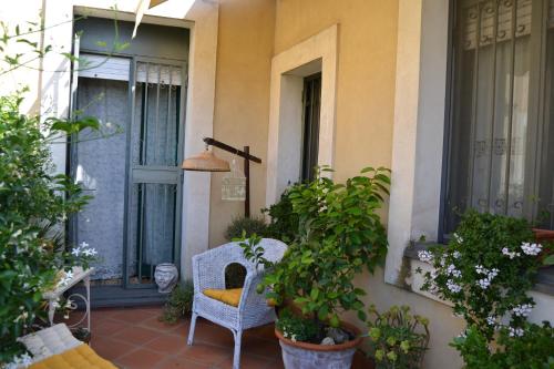 a porch with a chair and potted plants at B&B VELARDI in Viagrande