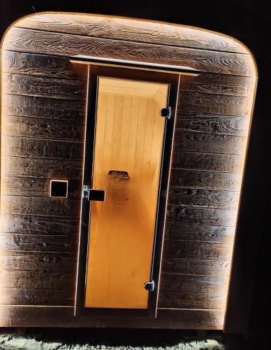 a picture of a door in a wooden box at Domek na Ubocy z jacuzzi, sauną i widokiem in Biały Dunajec