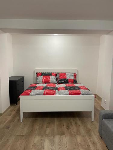a white bed with red pillows in a room at Apartment Patera 2 in Meziboři