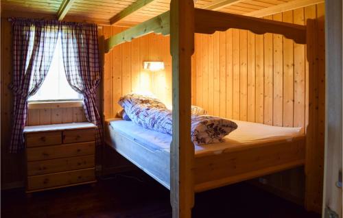 a bedroom with a bunk bed in a cabin at 3 Bedroom Amazing Home In Nord-torpa in Nord Torpa