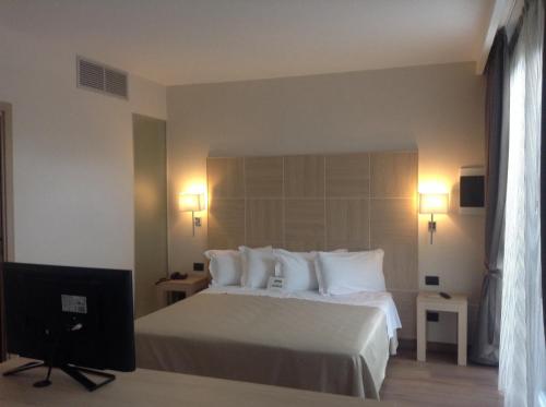 a hotel room with a bed and a television at Best Western Hotel Rome Airport in Fiumicino