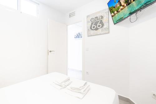 a white room with a tv hanging on the wall at Torre Levante 24-B Levante Beach in Benidorm