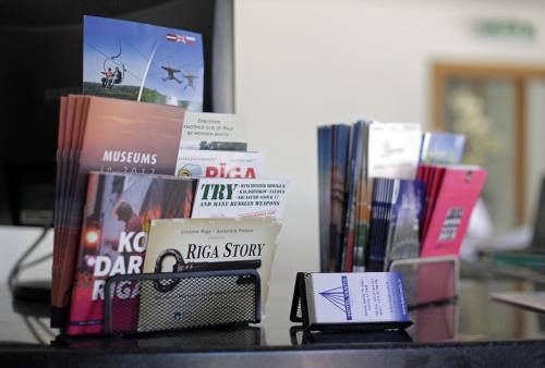 a table with books and a cell phone on it at Superior Hotel Vantis Riverside in Rīga
