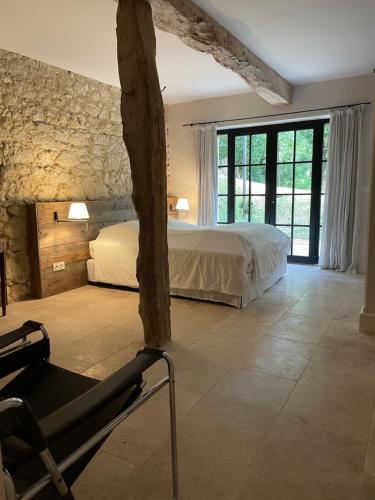 une chambre avec un lit et une chaise dans une pièce dans l'établissement Superbe propriété avec piscine, à Castet-Arrouy