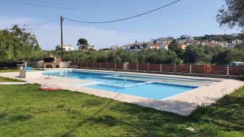 a swimming pool in the yard of a house at Mati- Cozy apartment- Close to the beach of Almyrida with a shared Pool in Chania