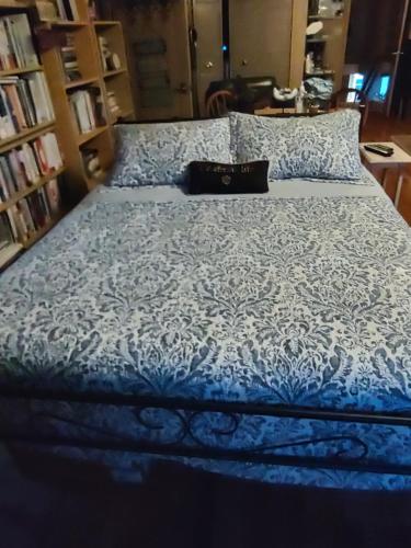 a blue and white bed with a black purse on it at Indys Hidden Gem in Indianapolis