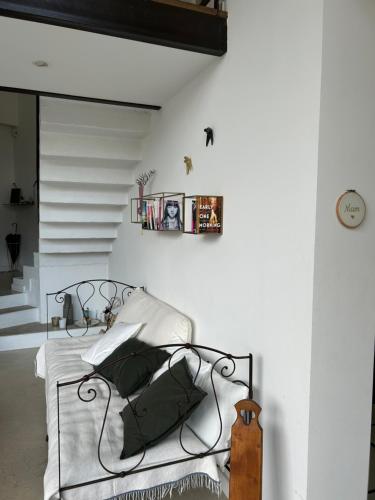 a bedroom with a metal bed with white pillows at My Home in lourmarin in Lourmarin