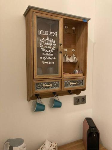 a wooden cabinet hanging on a wall at Komfortný apartmán A407 v centre NR, bez kuchyne, parkovisko zdarma in Nitra