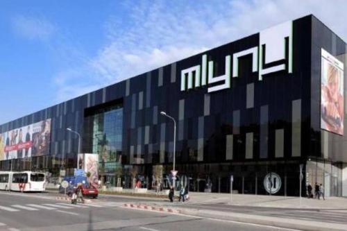 a large black building with a sign on the side of it at Komfortný apartmán A407 v centre NR, bez kuchyne, parkovisko zdarma in Nitra