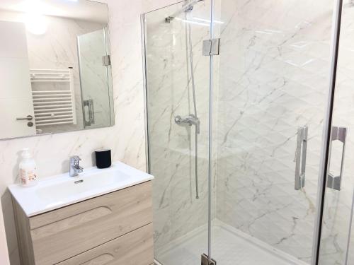 a bathroom with a shower and a sink at Unique Waterfront Duplex on the Mediterranean - Caleta, Catalan Bay in Gibraltar