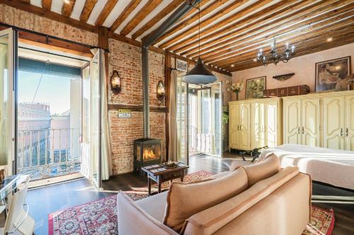a living room with a bed and a fireplace at 1851: Exceptional 19th century studio in Madrid in Madrid