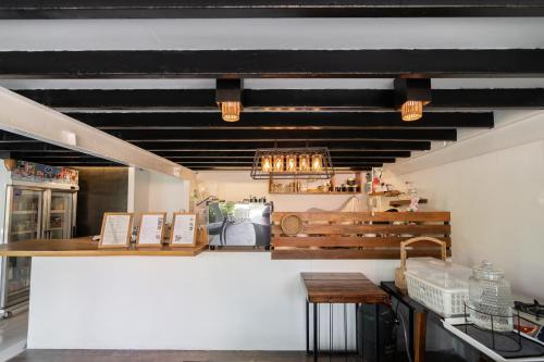 a kitchen with a table and a counter top at The Loft Panwa Resort in Panwa Beach