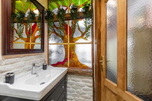 a bathroom with a sink and a stained glass window at 1851: Exceptional 19th century studio in Madrid in Madrid