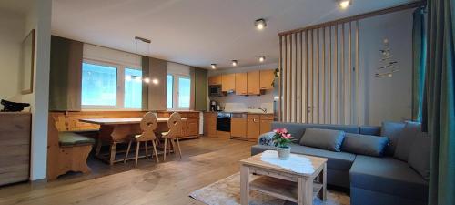 奧爾陶斯的住宿－s`Hauserl 311，客厅以及带沙发和桌子的厨房。