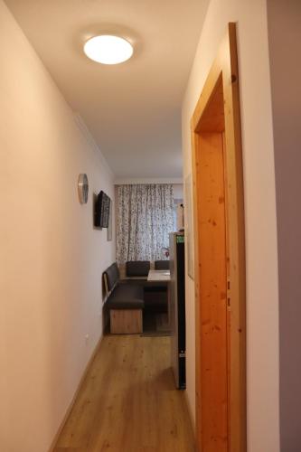 a hallway leading to a living room with a couch at Landhaus-Appartements Warraich in Schladming