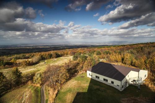 an aerial view of a white building on a hill at Rockwood Hotel & Spa in Ajigasawa