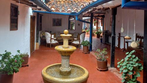 a fountain in the courtyard of a house at Hotel Casa del Marquez de Bahichala in Barichara