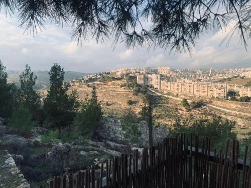 a view of a city from behind a fence at Nativity apartment Bethlehem in Bethlehem