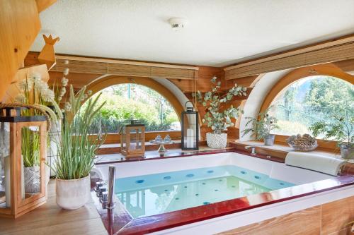 a jacuzzi tub in a room with windows at Witkówka WILD Luxury Apartments - Sauna & SPA in Witów