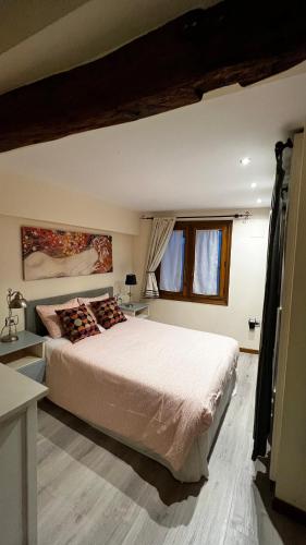 a bedroom with a large bed and two windows at Urrondo in Lekeitio
