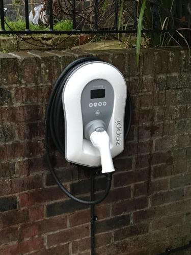 a hair dryer on the side of a brick wall at Stylish one bed apartment in the Stroud Valleys in Brimscombe