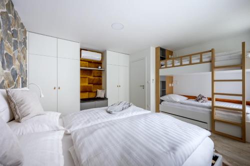two beds in a bedroom with two bunk beds at Apartmány u Lesa in Dolní Morava