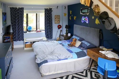 a bedroom with a bed with a teddy bear on it at Hurstpierpoint 3 bedroom House with Hot-Tub & Garden in West Sussex in Hurstpierpoint