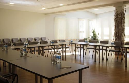 a large room with tables and chairs in it at Superior Hotel Vantis Riverside in Rīga