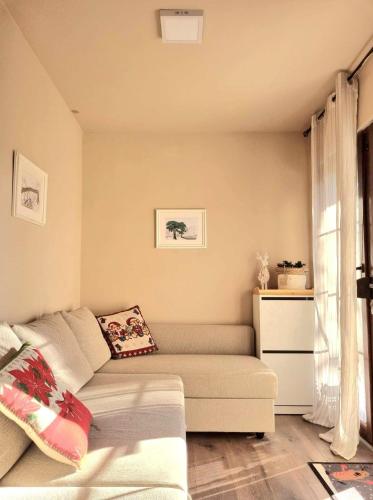 a living room with a couch and a window at Vila Lucic Zlatibor in Zlatibor