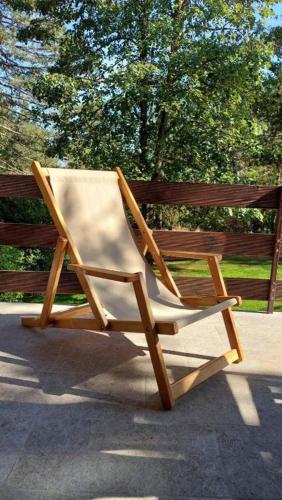 a wooden chair sitting next to a wooden bench at Vila Lucic Zlatibor in Zlatibor