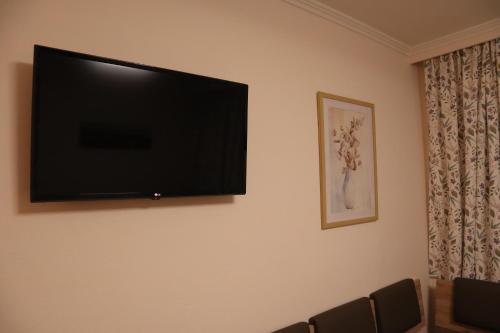 a flat screen tv hanging on a wall at Landhaus-Appartements Warraich in Schladming