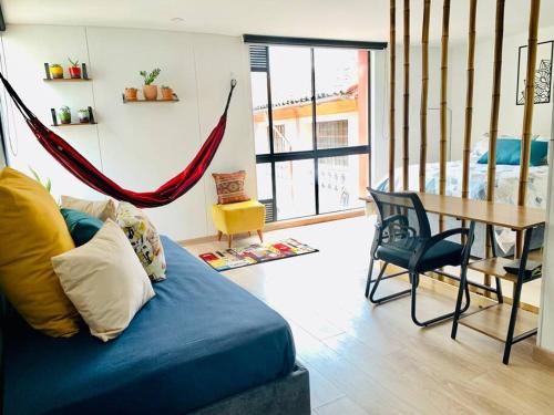 uma sala de estar com um sofá azul e uma rede de descanso em Amazing loft in La Candelaria em Bogotá