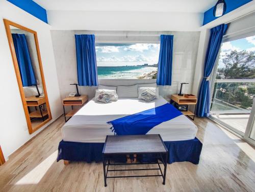 a bedroom with a bed with a view of the ocean at Paradise Beachfront & Nightlife Heart in Cancún