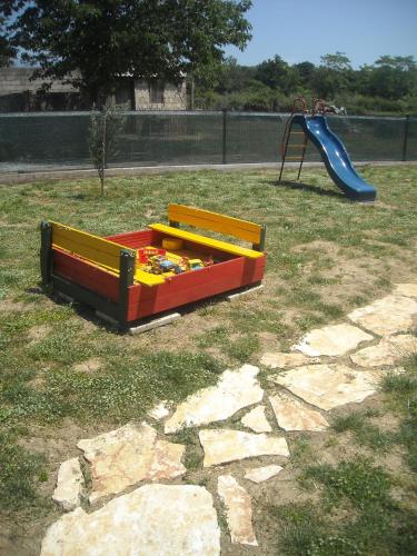 a playground with a play set and a slide at Apartments Kalac in Posedarje