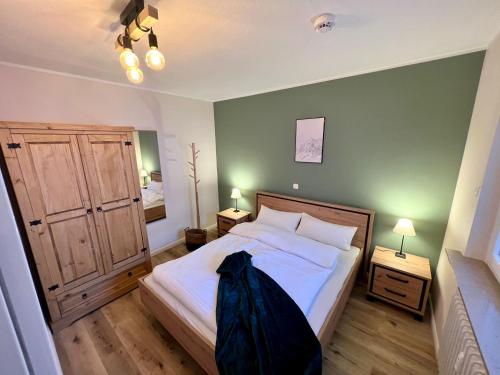 a bedroom with a bed and two night stands with two lamps at Mountain Lodge in Sankt Andreasberg
