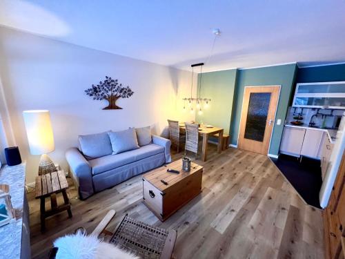 a living room with a couch and a table at Mountain Lodge in Sankt Andreasberg