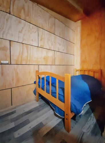 a bedroom with a blue bed in a room at departamentos don Pato in Castro