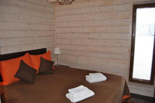 a bedroom with a bed with two towels on it at Kiurunrinne Villas in Imatra