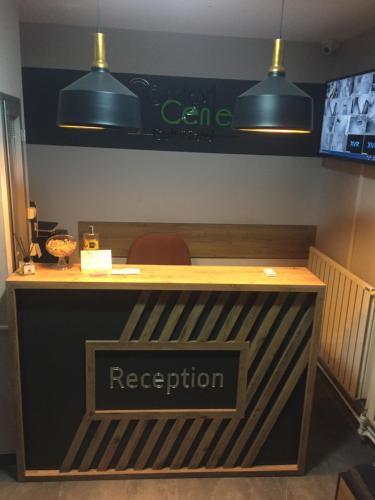 a reception desk with a sign that reads reception at Comfort Center Suit Hotel in Edirne