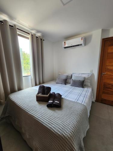 a bedroom with a bed with shoes on it at Taipu Lodge Beach in Marau