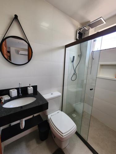 a bathroom with a toilet and a sink and a shower at Taipu Lodge Beach in Marau
