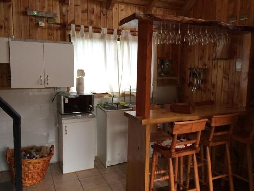 a kitchen with a counter and a sink and a stove at Pucón La Tita in Pucón