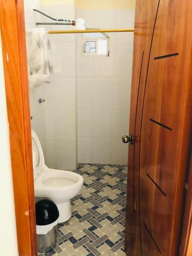 a bathroom with a toilet and a floor at Pelican House in Puerto Baquerizo Moreno