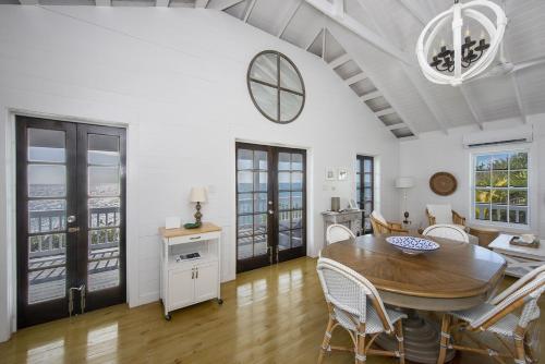 a kitchen and dining room with a table and chairs at Palm Bluff cottage in Gregory Town