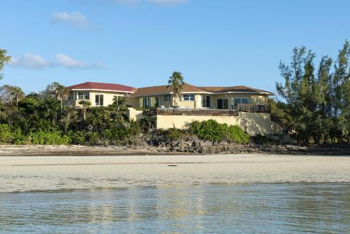 a house on the shore of a beach at Sand Dollar at Ten Bay Beach home in Savannah Sound