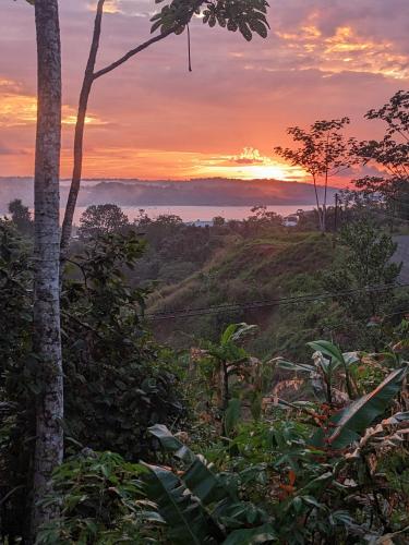 a sunset in the jungle with a view of the ocean at La Katalinda in Drake