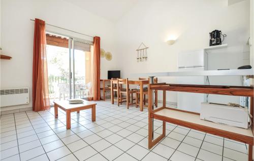 a kitchen and dining room with a table and chairs at Awesome Apartment In Sainte-Maxime in Sainte-Maxime