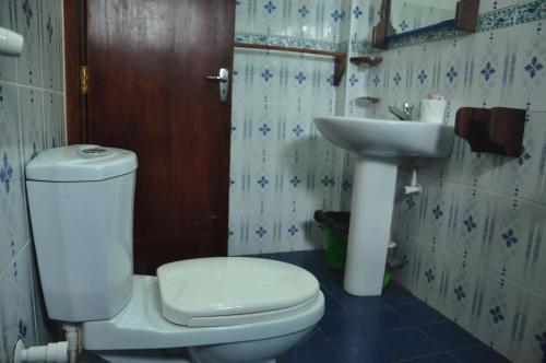 a bathroom with a toilet and a sink at Resort Deepika Mirissa in Mirissa