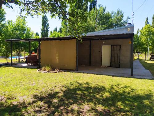 un pequeño edificio con garaje en un patio en Casa Rural La Serena Cabaña en San Rafael