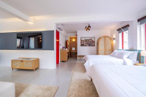 a bedroom with two beds and a living room at Leiden Homestay&Cafe' in Ho Chi Minh City